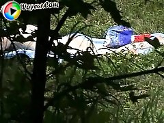 3 movies - A suntanning naked redhead unsuspecting of a peeping tom in the woods by real voyeurist
